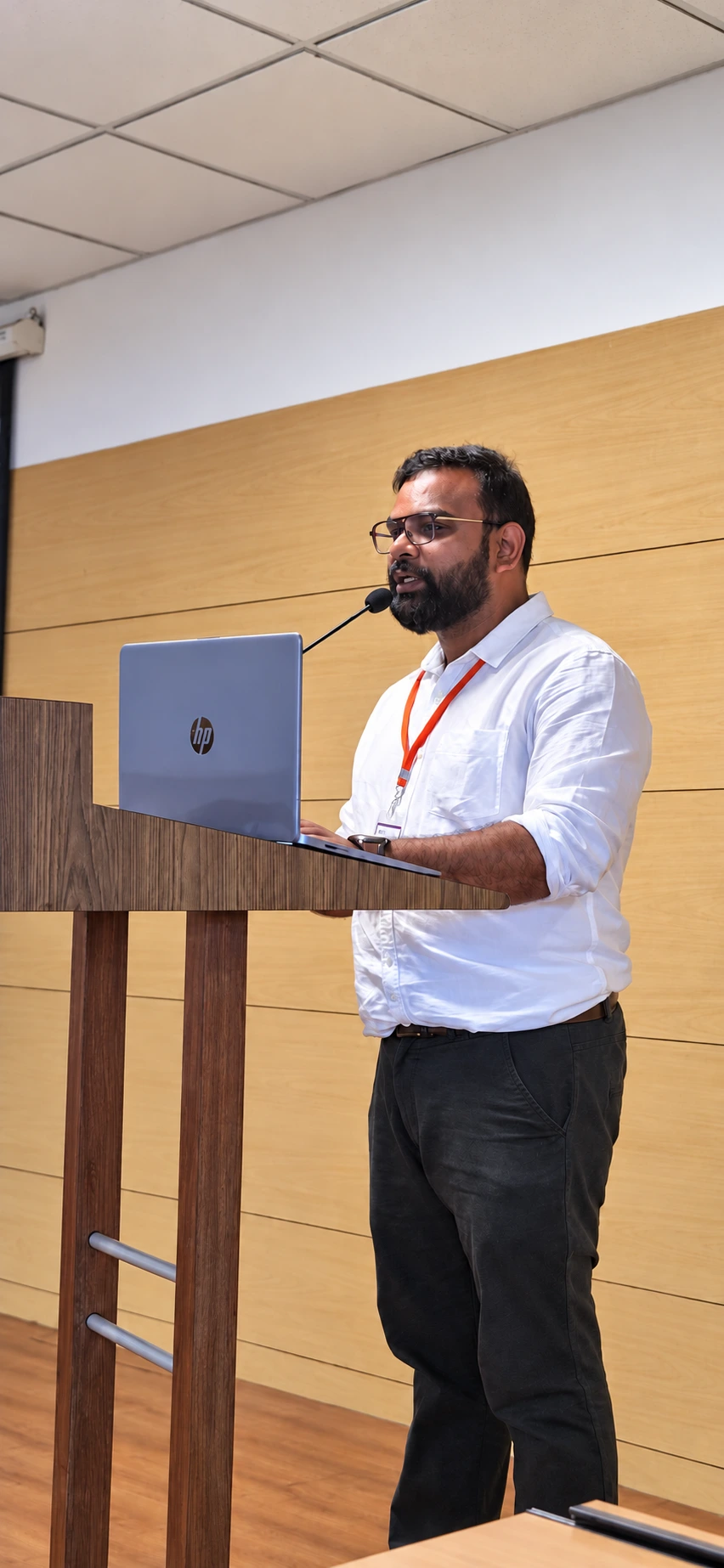 Dr. Akash K speaking at a lectern